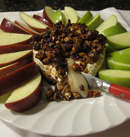 Luxurious melted baked brie topped with caramelized almonds glazed in premium Gustare Bourbon Maple Balsamic Vinegar