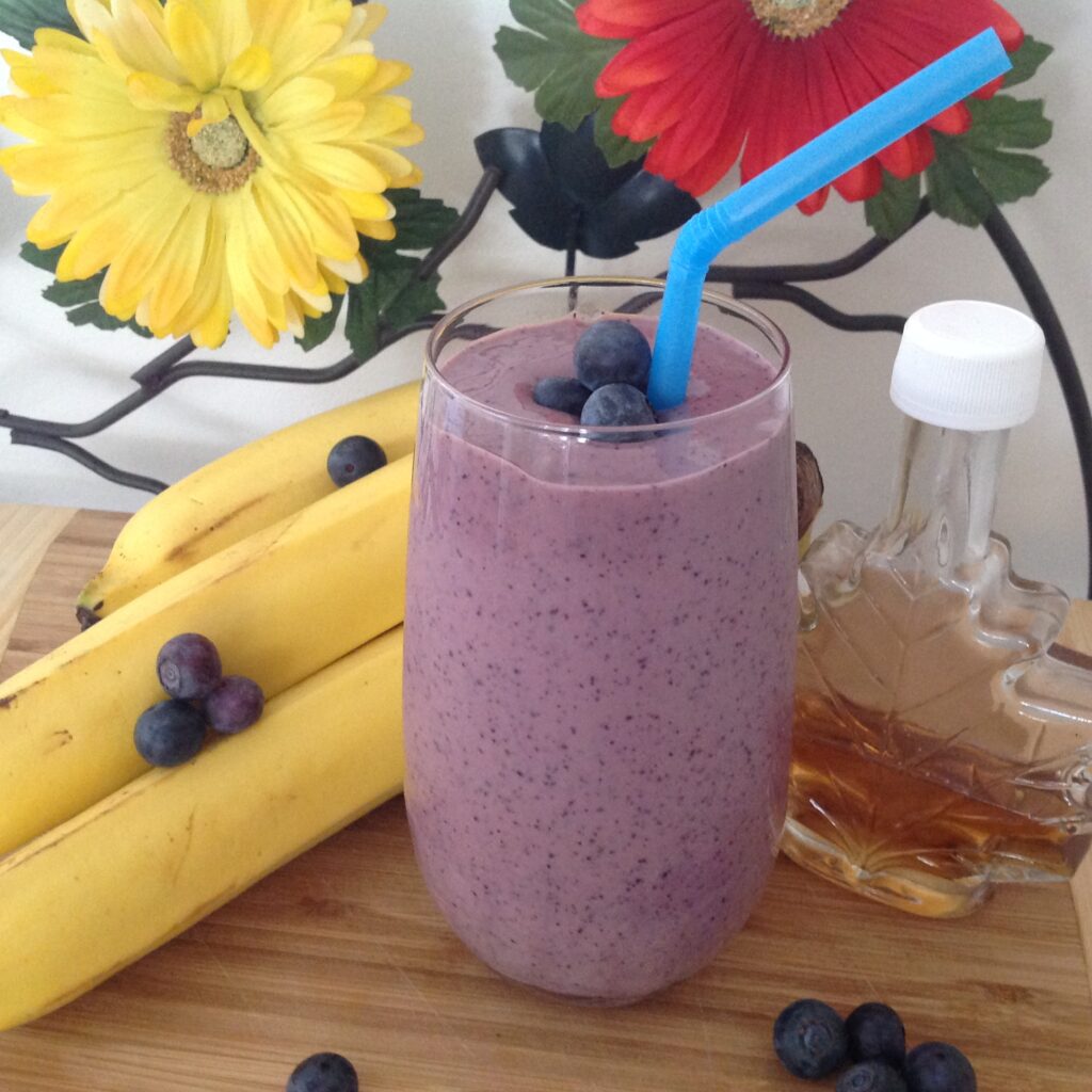 Thick and creamy blueberry banana protein power smoothie made with Gustare Wild Blueberry Balsamic Vinegar, a healthy high-protein drink recipe for an energized morning