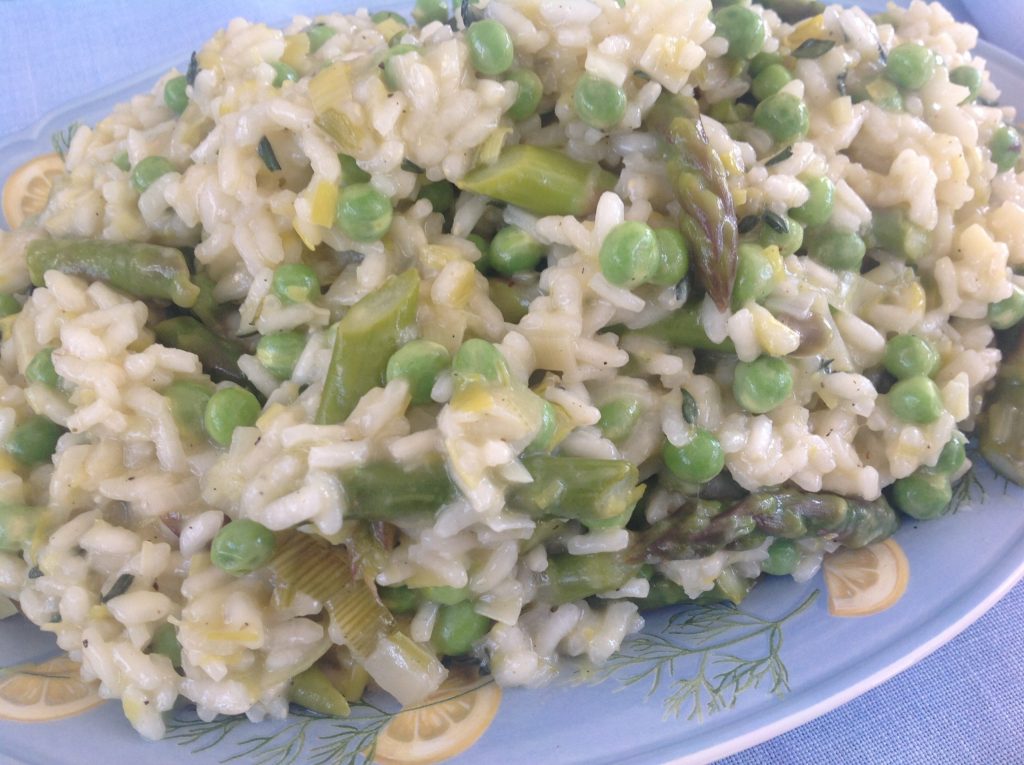 Creamy spring risotto bursting with fresh asparagus and peas, finished with Gustare Italian Whole Fruit Lemon Olive Oil for a bright, gourmet twist on a classic Italian main course