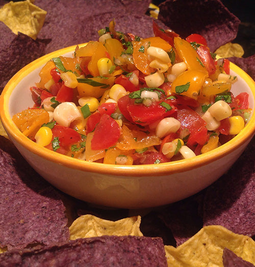 Sweet and spicy tomato-corn salsa with Gustare Habanero Honey Balsamic in a yellow serving bowl