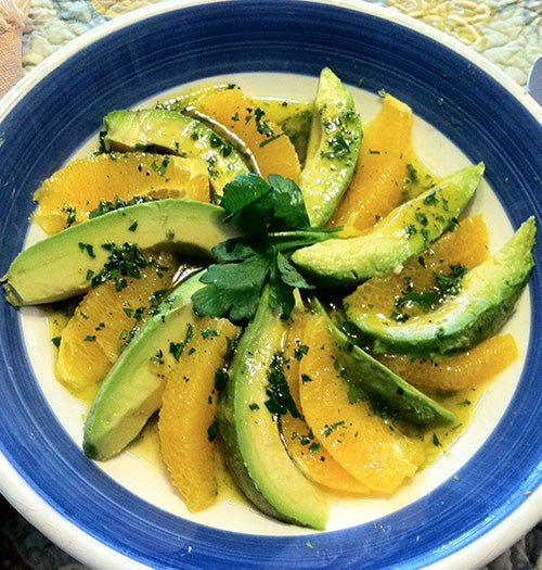 Sicilian orange and avocado salad drizzled with Gustare Coratina Extra Virgin Olive Oil, a fresh and elegant gourmet salad recipe using premium artisan olive oil