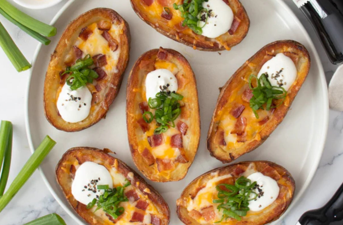 Air fryer truffled potato skins with Gustare White Truffle Olive Oil, bacon, and sour cream