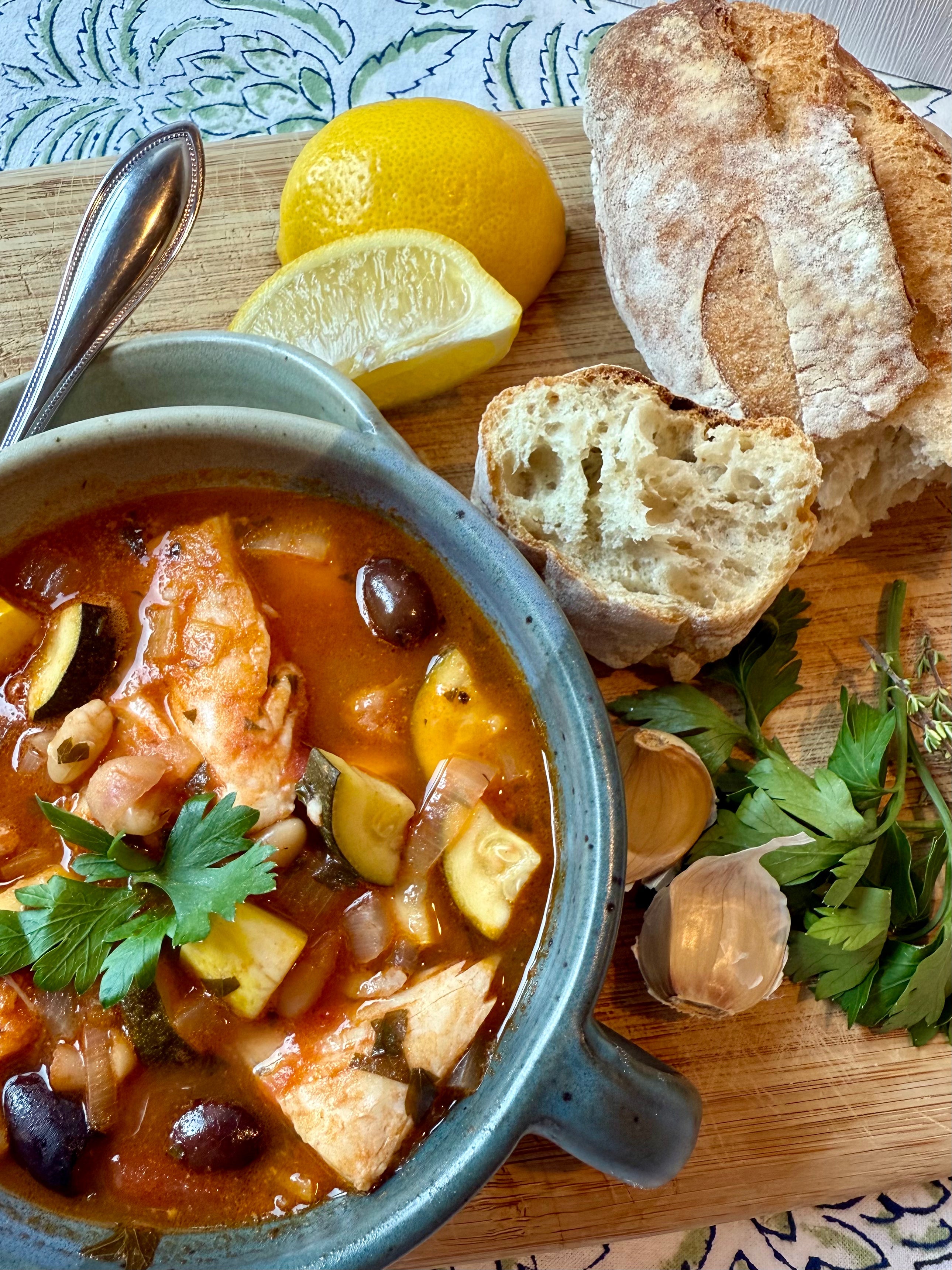 Cape Rustic Cape Cod Fish Stew made with premium Gustare Tuscan Herb Extra Virgin Olive Oil, featuring tender cod, colorful vegetables, and Kalamata olives in a rich tomato brothCod Fish Stew