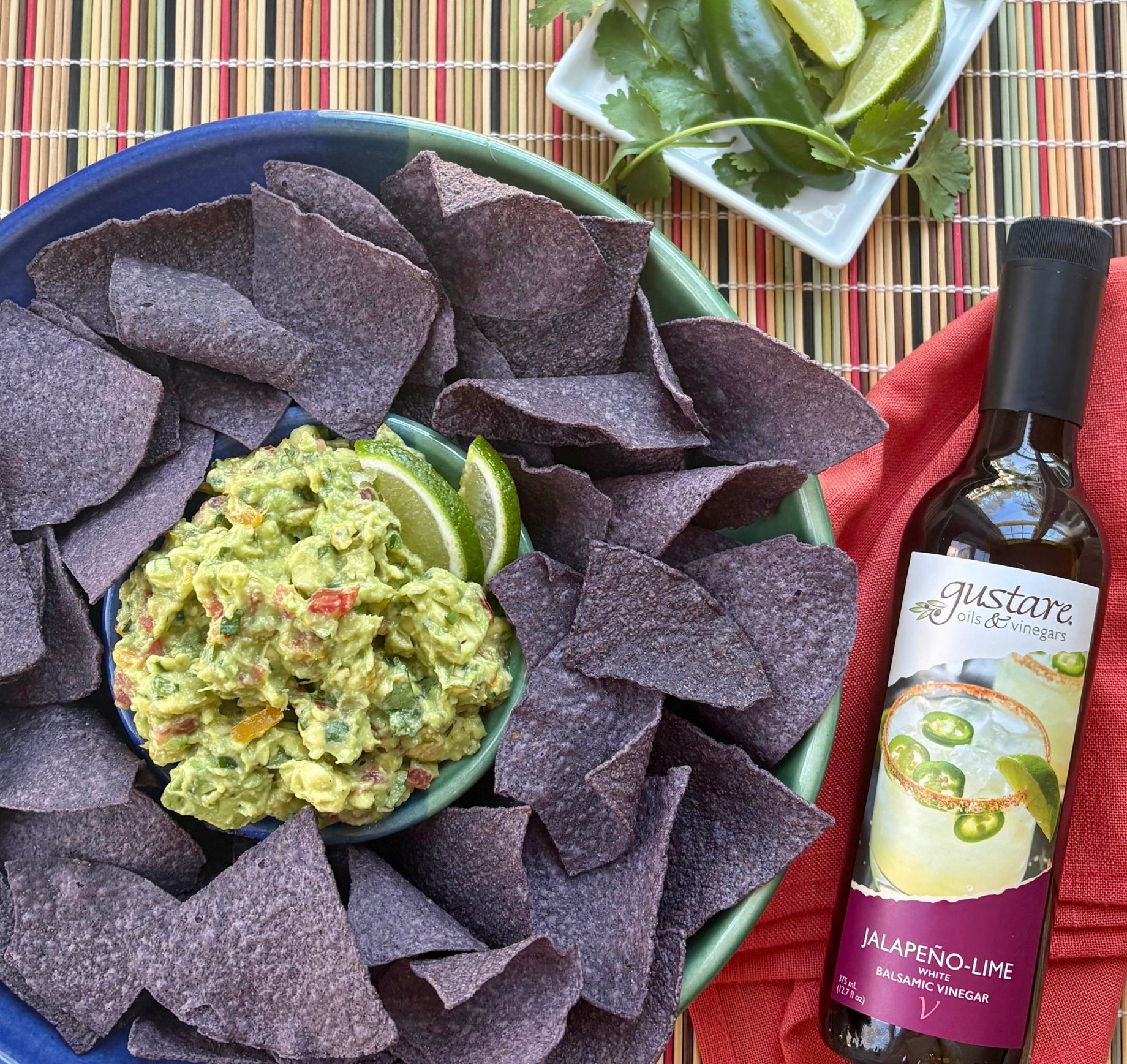 Fresh homemade guacamole featuring ripe avocados, zesty lime, and Jalapeño-Lime balsamic vinegar.